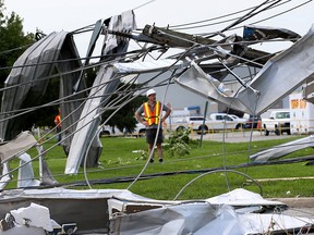 Twisted mess of power lines, building panels and tree limbs, the result of a tornado which cause havoc on Deziel Drive and Kautex Drive Wednesday night. Emergency and repair crews had their hands full, Thursday. (NICK BRANCACCIO/Windsor Star)