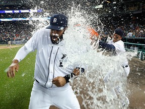 Detroit Tigers' J.D. Martinez is doused with water by Jose Iglesias after beating the Chicago White Sox 2-1 in a baseball game Wednesday, Aug. 3, 2016 in Detroit. (AP Photo/Paul Sancya)