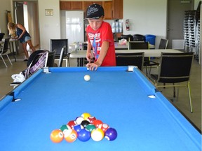 Phoenix Cheeseman, 12, lines up for the break during a pool game at the LaSalle Hangout for Youth centre on Wednesday, August 31, 2016.