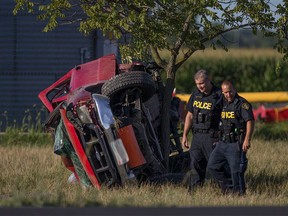 OPP officers investigate a single-vehicle crash on County Road 46 near Richardson Side Road in Lakeshore on Saturday, Aug. 6, 2016.