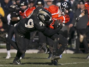 Ottawa's Joey McDonald is wrapped up by AKO's Adam Slikboer during the Ontario Football Conference championship game at E.J. Lajeunesse, Sunday, Nov. 1, 2015. The AKO Fratmen won their third straight title beating the Sooners 21-11. This year the Fratmen and the Ontario Football Conference will return to national competition.