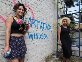 Windsor artist Briana Athena Benore (left) and Art Attack Windsor founder Jill Thompson (right) by the wall at 409 Ouellette Ave. on Aug. 1, 2016. The site is the target for the second mural of the Art Attack Windsor project.