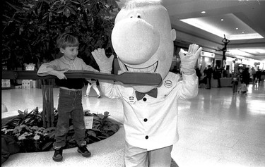 April 16, 1990: Bob Alive plugs dental health with an assist from five-year-old Ross Murchison, standing on a fountain during Dental Health Week at Devonshire Mall.