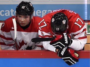 Canada's John Quenneville (22) and Travis Konecny (17) react to their team's loss against Finland following quarter-final hockey action at the IIHF World Junior Championship, in Helsinki, Finland, on Saturday, Jan. 2, 2016.