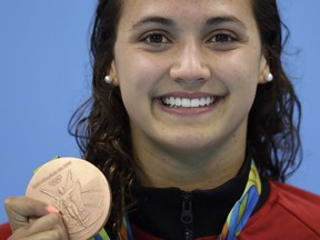 Canada's Kylie Masse shows off her bronze medal after the women's 100-metre backstroke final on Aug. 8 at the 2016 Summer Olympics in Rio de Janeiro, Brazil.