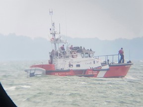 A Canadian Coast Guard boat is seen searching for a missing person near the southern tip of Pelee Island on Aug. 20, 2016.