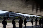 Military soldiers patrol under a bridge outside of Maracana Stadium. A motorcyclist shot and killed by police outside Maracana Stadium while the opening ceremony was on.