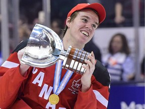 Canada's Connor McDavid skates with the trophy following his team's gold-medal victory over Russia at the IIHF World Junior Championship in Toronto on Jan. 5, 2015.