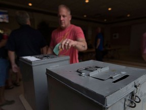 An autoworker and Unifor member casts his strike action vote on Aug. 28, 2016 at the Caboto Club.