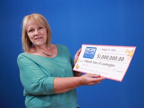 Deborah Ware of Leamington with her prize cheque after winning $1 million through ENCORE on a Lotto MAX ticket.