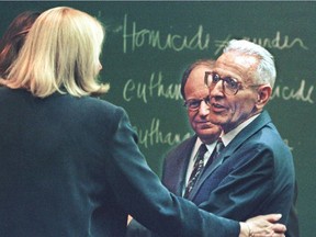 PONTIAC, :  Dr. Jack Kevorkian is held by Ruth Holmes (L), a jury consultant, and Mike Morganroth (R), one of his legal advisors after he was convicted of second degree murder in Oakland County Circuit Court 26 March 1999 for giving Thomas Youk, a terminally ill man, a lethal injection.