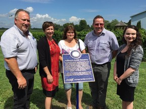 Essex Deputy Mayor Richard Meloche, from left, Essex CAO Tracey Abbs-Pillon, Essex Municipal Heritage Committee members Laurie Kowtiuk, Phil Pocock and Rita Jabbour unveil a bronze heritage plaque at the Tofflemire Snider Cemetary on August 25, 2016.