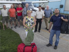 Ruth Kivinen, centre-left, from St. Mary's Anglican Church, and Martin Reeb, president of the Windsor Flying Club, are pictured with pilots participating in Operation Point North at the Windsor Flying Club, Thursday, August 25, 2016.