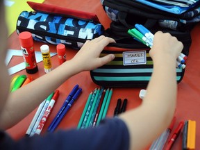A child prepares school supplies in this Sept. 1, 2013 file photo.