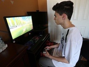 Brandon Lachin, 16, plays Rocket League at home in Tecumseh. Lachin is part of the top-ranked Rocket League team in the world. On Aug. 7, the team won $27,500 at the first Rocket League Championship Series in Los Angeles.