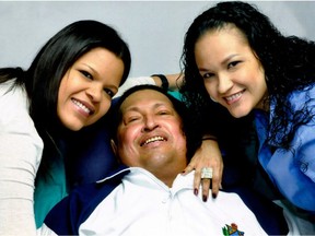 FILE - In this file photo released on Feb. 15, 2013 by Miraflores Presidential Press Office, Venezuela's President Hugo Chavez, center, poses for a photo with his daughters, Maria Gabriela, left, and Rosa Virginia at an unknown location in Havana, Cuba, Thursday, Feb. 14, 2013. Venezuela's government says that President Hugo Chavez's respiratory problems have gotten worse and that the ailing leader is in "very delicate" condition. Venezuela's Communications Minister Ernesto Villegas said late Monday, March 4, 2013, in a statement read on national television that the cancer-stricken socialist leader has a "severe infection." (AP Photo/Miraflores Presidential Press Office, File) ORG XMIT: XLAT112