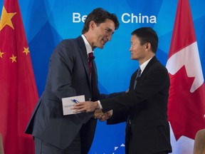 Canadian Prime Minister Justin Trudeau speaks with China Entrepreneur Club chairman Jack Ma after participating in a question and answer session in Beijing, China Tuesday Aug. 30, 2016.