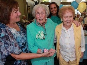 Millie Shepherd, 104, and Marie McGuire, 101, right, celebrate their birthday at Chartwell Kingsville Retirement Residence Wednesday Aug. 10, 2016. Assisting were Chartwell staffers Connie Bolsover, left, and Jacinta Colasanti, behind.