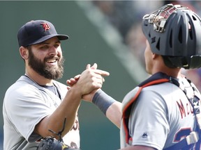 Detroit Tigers starting pitcher Michael Fulmer is congratulated by catcher James McCann after Fulmer pitched a four-hitter against the Texas Rangers on Sunday, Aug. 14, 2016, in Arlington, Texas.