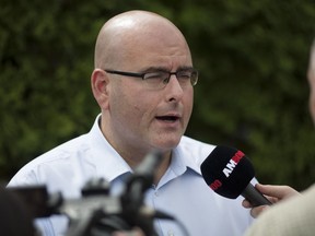 Transportation Minister, Steven Del Duca, talks to the media after taking a bus tour of Highway 3 with local politicians Sunday, Aug. 14, 2016.
