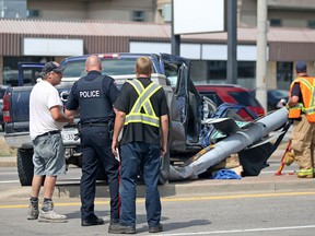 Dennis Ciotti talks to a Windsor police officer after his pickup truck was involved in a crash at Lauzon and Little River roads in Windsor on Thursday, Aug. 11, 2016. The crash sent the passenger of the pickup truck, an 11-year-old boy, to hospital.
