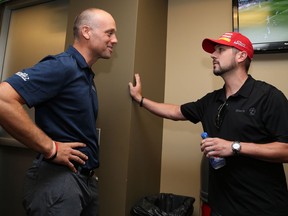 Detroit Red Wings head coach, Jeff Blashill, left, speaks with Michael Annett, driver of the #46 Pilot Flying J Chevrolet, after a press conference at the NASCAR Sprint Cup Series Pure Michigan 400 at Michigan International Speedway on August 28, 2016 in Brooklyn, Michigan.