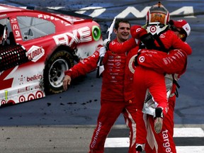 Kyle Larson, driver of the #42 Target Chevrolet, celebrates with crew members after winning the NASCAR Sprint Cup Series Pure Michigan 400 at Michigan International Speedway on Aug. 28, 2016 in Brooklyn, Mich.