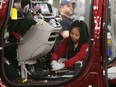 Windsor Assembly plant worker Tina Nguyen is all smiles while working on a 2017 Chrysler Pacifica on May 6, 2016.