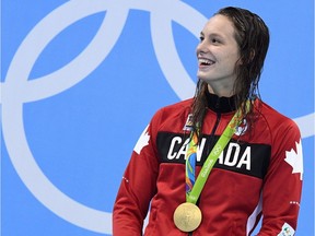 Canada's Penny Oleksiak celebrates her gold medal in the women's 100m freestyle finals during the 2016 Olympic Summer Games in Rio de Janeiro, Brazil, on Friday, Aug. 12, 2016. A week ago Oleksiak was just one of the many anonymous athletes about to embark on her first Olympic Games. Seven days and four medals later, she's a national hero being touted as a Canadian Michael Phelps, a fresh-faced star with seemingly limitless potential.