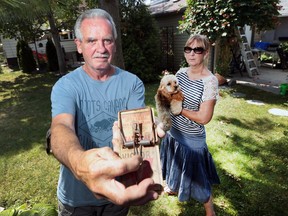 Robert and Barbara Hart are shown in their backyard on Aug. 5, 2016 with a rat trap they regularly use.