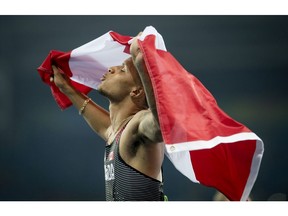 RIO-OLYMPICS-POSTMEDIA  RIO, ONTARIO : August 14, 2016 - Andre De Grasse, of Canada, celebrates his bronze medal in the men's 100m final at the Rio 2016 Olympic Games in Rio de Janeiro, Brazil, , Sunday, August 14, 2016.   (Tyler Anderson / National Post)  (For Postmedia Olympic Coverage) ORG XMIT: POS1608142053151149 ORG XMIT: POS1608142101431352