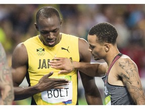 RIO-OLYMPICS-POSTMEDIA  RIO, ONTARIO : August 18, 2016 - Andre De Grasse, of Canada, congradulates Usain Bolt, of Jamaica, following the men's 200m final at the Rio 2016 Olympic Games in Rio de Janeiro, Brazil, Thursday, August 18, 2016. Bolt took the gold medal and De Grasse took silver.  (Tyler Anderson / National Post)  (For Postmedia Olympic Coverage)