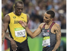 RIO-OLYMPICS-POSTMEDIA  RIO, ONTARIO : August 18, 2016 - Andre De Grasse, of Canada, congradulates Usain Bolt, of Jamaica, following the men's 200m final at the Rio 2016 Olympic Games in Rio de Janeiro, Brazil, Thursday, August 18, 2016. Bolt took the gold medal and De Grasse took silver.  (Tyler Anderson / National Post)  (For Postmedia Olympic Coverage)