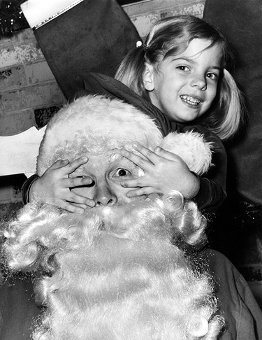 Dec. 23, 1976: Ruth Ellen Wilson enjoys her visit with Santa at the Devonshire Mall even to the point of playing peek-a-boo on the kindly old fellow.