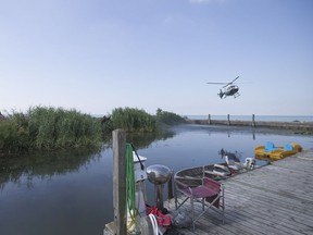 An OPP helicopter lifts off from the end of the Colchester Harbour Marina, Monday, Aug. 1, 2016. The body of Laura Del-Bel, 56, was discovered around 8:45 p.m. Monday.