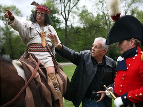 Sculptor Mark Williams gives instructions to actors portraying War of 1812 heroes Chief Tecumseh and Gen. Sir Isaac Brock at Paterson Park on May 17, 2014.