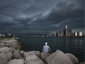 Sherif Messiri watches as a storm front moves into Windsor from Michigan, Saturday, August 27, 2016.