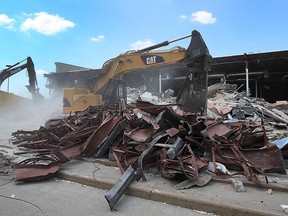 An excavator takes down walls at the former Target location in the Devonshire Mall on Aug. 3, 2016.