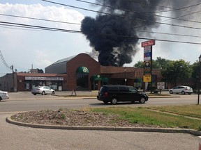 Black smoke billows from a fire in the 1200 block of Shawnee Road on July 31, 2016.