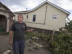 David Andrukonis cleans up debris from a tornado at his house on Riberdy Road where he's lived for 27 years with his wife Debra Andrukonis, Thursday, August 25, 2016.