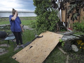 Debra Andrukonis surveys the tornado damage to her backyard on Riberdy Road on Aug. 25, 2016. Andrukonis has lived at the home for 27 years with her husband David Andrukonis.