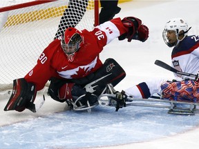 Kingsville native Corbin Watson, left, makes a save against the United States' Rico Roman during the Sochi Paralympic Games on March 13, 2014.