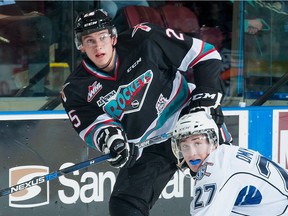 Cal Foote, left, of the Kelowna Rockets takes a shot on net against the Victoria Royals during WHL action on Oct. 9, 2015 at Prospera Place in Kelowna, B.C.