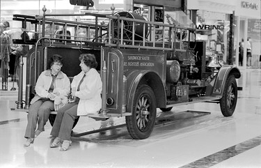 Oct. 9, 1990: Ivy Maisonville, 80, and Jeanette Maisonville, 78, found a comfortable spot on the rear of this vintage fire truck being shown at Devonshire Mall as part of Fire Prevention Week.