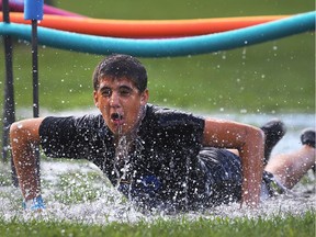 The second annual In Honour of the Ones We Love water balloon fight event was held on Sunday, August 21, 2016, at the Lanspeary Park Nathan Sauve, 14, gets drenched competing in the wet obstacle course race.