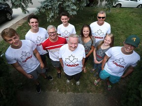 Bill Van Wyck, centre, is joined by Connor Moxley, from left,  Jake Chalut, Mike Chalut, Max Cooney, Sylvia Dean, Steve Chamko, Ella Doornaert and Lukas Scarfe in front of his home in Windsor on Aug. 12, 2016. Van Wyck is taking 10 kids and chaperones to the Olympics in Brazil.