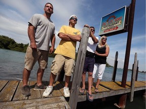 The Beattie family - Tom Jr. (left), Joe, Tom Sr. and Sal - have begun rebuilding the former Lampookie's Marina in LaSalle. They are shown at the marina on  Aug. 24, 2016.