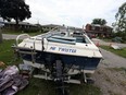 How fitting: A powerboat with the name "Mr. Twister" rests in a driveway as crews work to clean up and repair the damage from a tornado on Victory Street in LaSalle on Thursday, Aug. 25, 2016. The tornado cut a narrow path several blocks long and caused extensive damage to several homes.