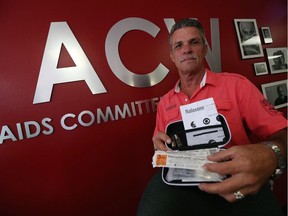 Byron Klingbyle shows off a Naloxone kit as the Aids Committee of Windsor office in Windsor on Friday, August 26, 2016. The kits are intended to buy time for people who may have overdosed on an opioid drug.