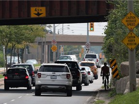 A cyclist  squeezes through the Dougall Avenue underpass on Wednesday, Aug. 31, 2016.